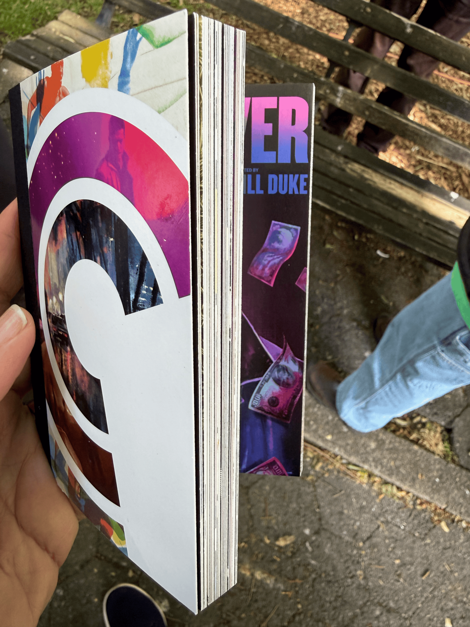 A postcard book, pretty thick, half open to a Deep Cover movie poster postcard.