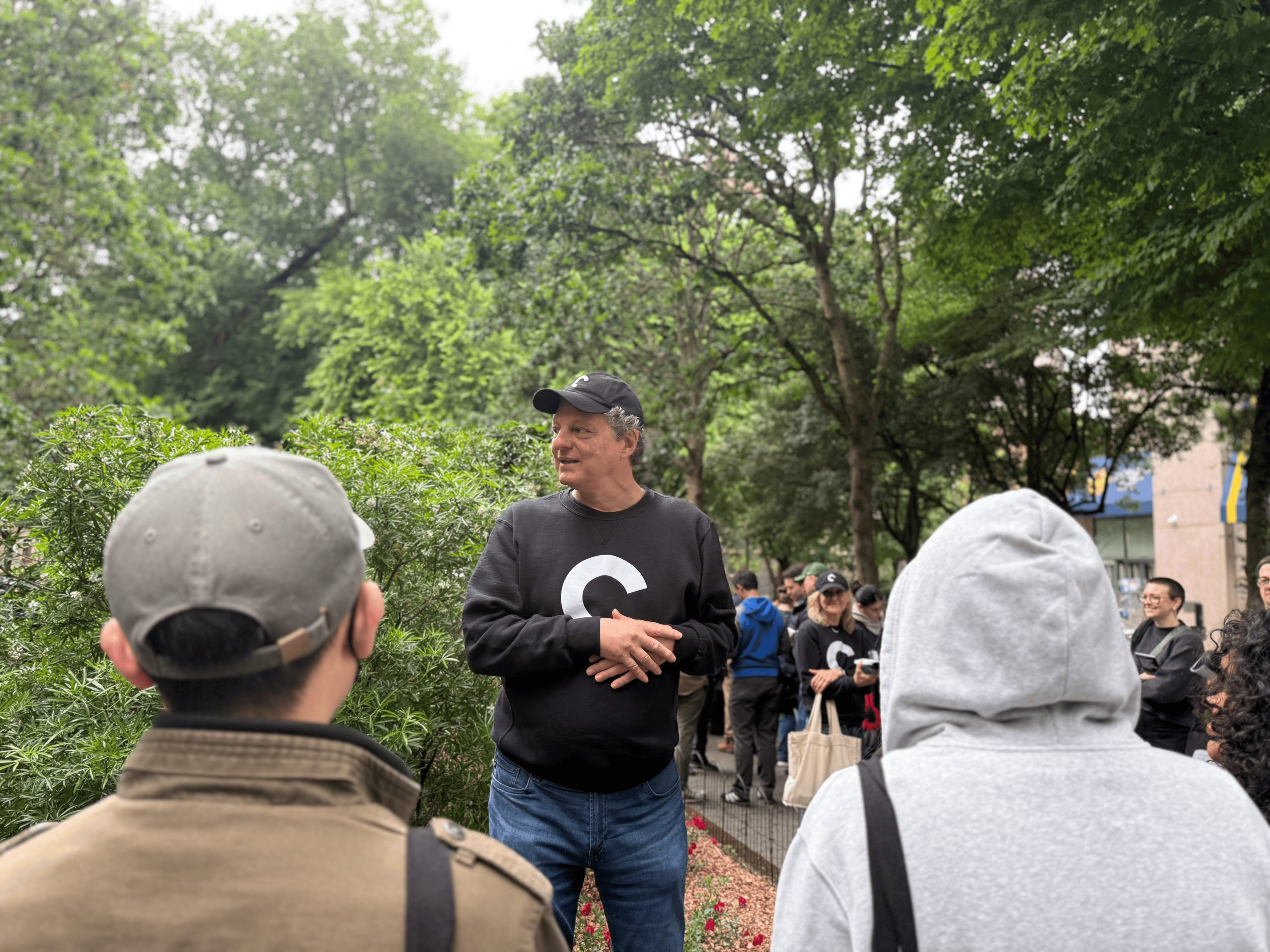 A gentleman in a Criterion sweatshirt and ball cap speaking to the line.